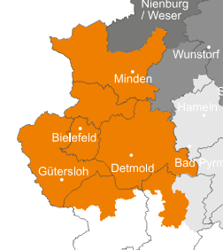 Ansprechpartner Karte der Region Detmold in orange mit Städten wie Bielefeld, Gütersloh, Detmold und Minden. Die Nachbarregionen in grau zeigen Städte wie Nienburg/Weser und Hameln.