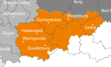 Ansprechpartner Orangefarbene Karte einer Region in Mitteldeutschland mit den Städten Magdeburg, Oschersleben, Halberstadt, Wernigerode, Quedlinburg und Zerbst; die umliegenden Gebiete sind grau eingezeichnet.